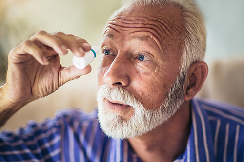 Older Man Putting in Eyedrops